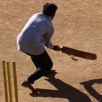 Morning cricket in a dirt lot, Bangalore