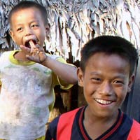 Hanso and a brother at their thatched home